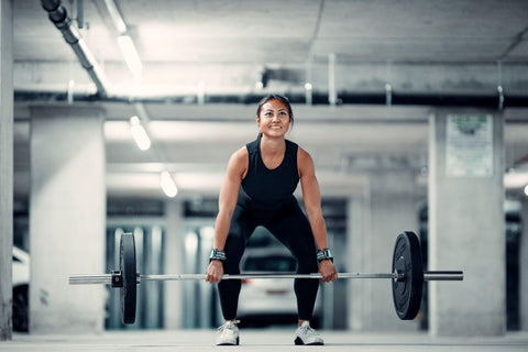Female weightlifter working out with Versa Gripps