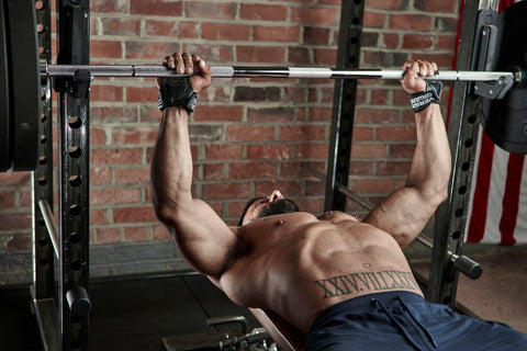 Male weightlifter using Versa Gripps while bench pressing