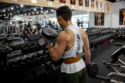 Male weightlifter usinga lifting belt and Versa Gripps during a workout