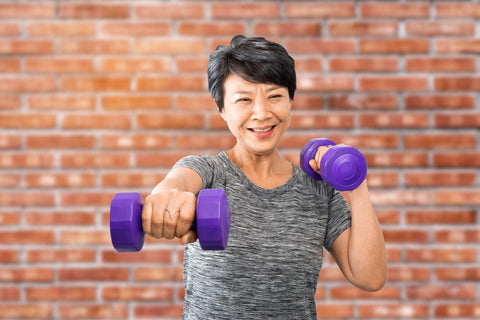 Older Asian woman doing a weightlifting workout