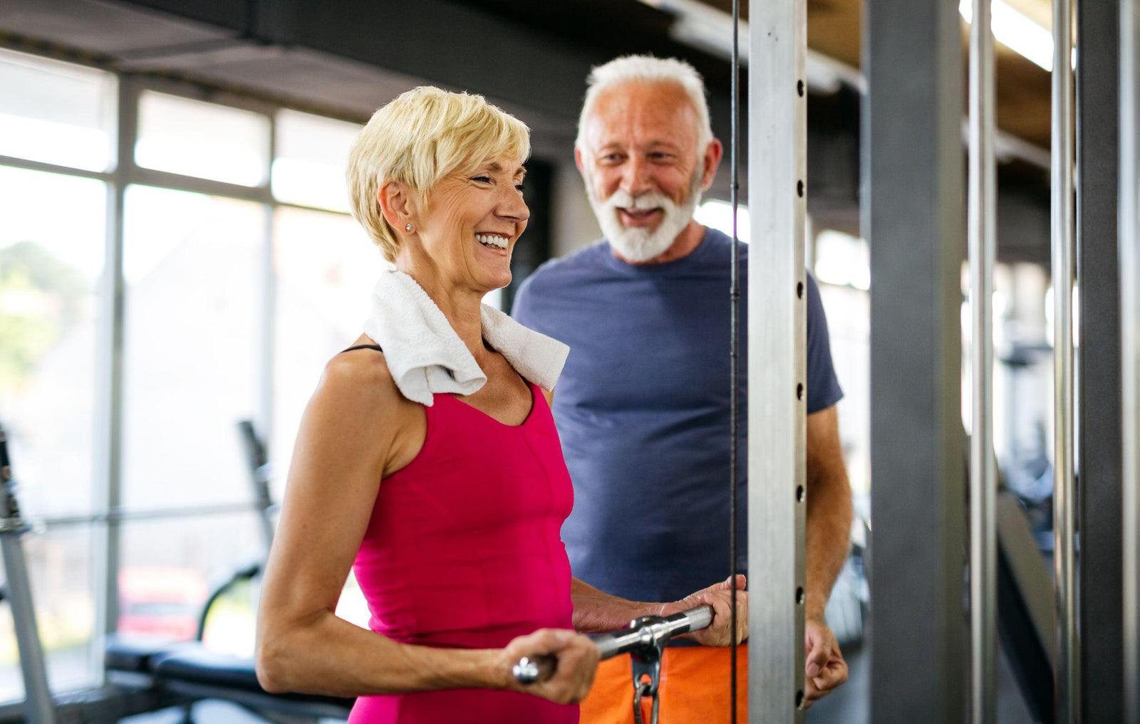 Older woman and man weightlifting together