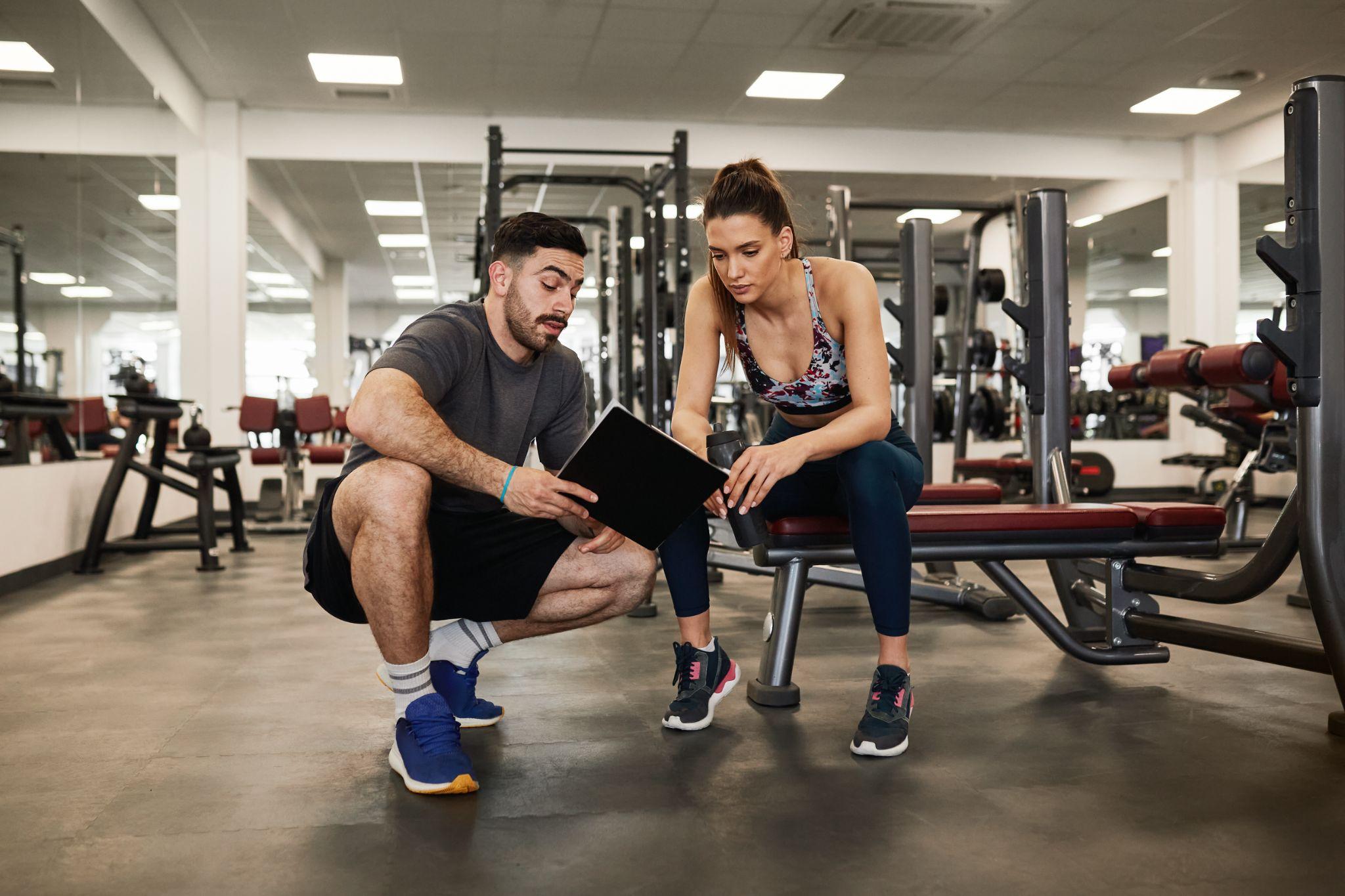 Personal trainer working with a client in the gym