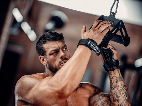 Weightlifter using Versa Gripps inside a home gym workout